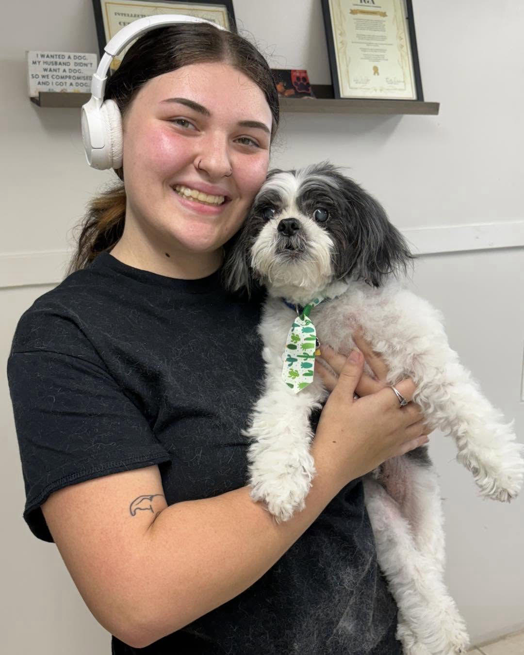 Smiling groomer holding a freshly bathed Shih Tzu at Southshore Pet Grooming in Ruskin, FL